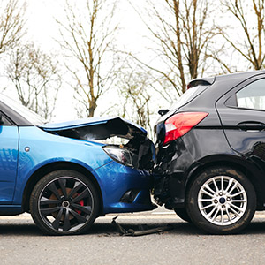 Two cars after a collision, symbolizing auto accident claims and legal representation.
